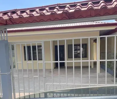 a house with a fence in front of it at Casa De Daniel in Daniel Flores