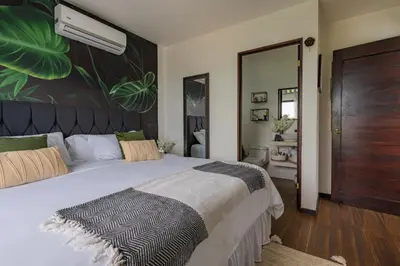 a bedroom with a large bed with a large plant wall at La Vista in Piedras