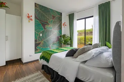 a bedroom with a bed with a large window at La Vista in Piedras