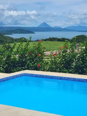 a swimming pool with a view of the water at La Vista in Piedras