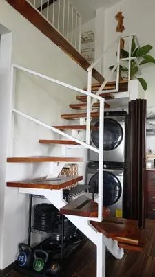 a room with wooden shelves in a kitchen with a refrigerator at La Vista in Piedras