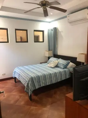 a bedroom with a bed and a ceiling fan at Playa Grande, Las Baulas National Park BnB in Playa Grande