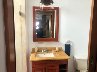a person taking a picture of a bathroom sink at Playa Grande, Las Baulas National Park BnB in Playa Grande