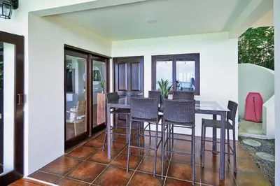 a dining room with a table and chairs at Luxury Ocean View Villa with Infinity pool in Santa Teresa Beach
