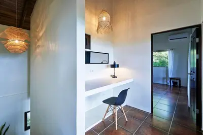 a dining room with a chair and a table at Luxury Ocean View Villa with Infinity pool in Santa Teresa Beach