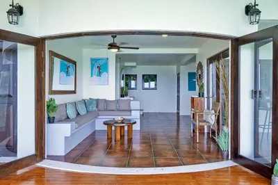 a living room with a couch and a table at Luxury Ocean View Villa with Infinity pool in Santa Teresa Beach