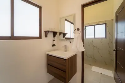 a bathroom with a sink and a shower at Corozalito Turtle Inn in Nandayure