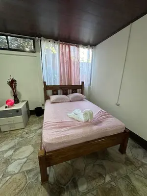 a bedroom with a bed with a dog laying on it at Vacaciones en Tortuguero in Tortuguero