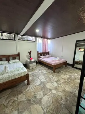 a bedroom with two beds in a room at Vacaciones en Tortuguero in Tortuguero