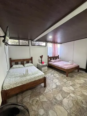 a bedroom with two beds in a room at Vacaciones en Tortuguero in Tortuguero