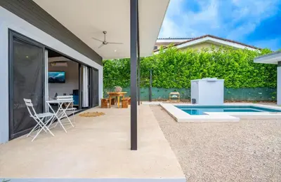 a patio with a pool and a table and chairs at Villa Paradise in Guatemala