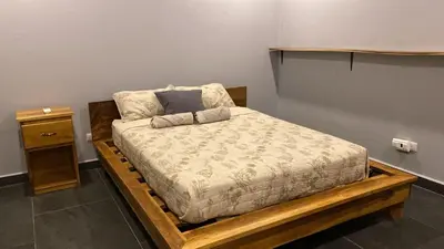 a bedroom with a bed on a wooden platform at Villa Paradise in Guatemala