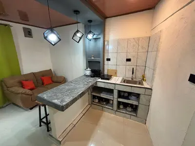 a kitchen with a sink and a couch in a room at Steps by Monteverde in Monteverde Costa Rica