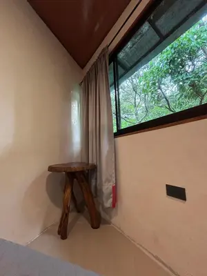 a small wooden table in a room with a window at Steps by Monteverde in Monteverde Costa Rica