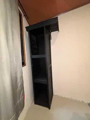 a black cabinet in the corner of a room at Steps by Monteverde in Monteverde Costa Rica