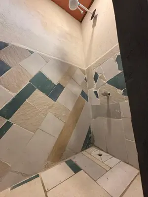 a bathroom with a shower with a tiled floor at Steps by Monteverde in Monteverde Costa Rica