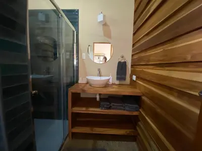 a bathroom with a sink and a shower at Casa Heliconia - Gorgeous Garden Home in Delicias in Puntarenas