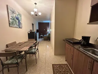 a kitchen and dining room with a table and a sink at Vargas Lodge, Costa Rica in San Vicente