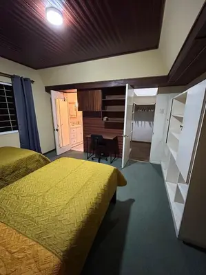 a bedroom with a bed and a desk in it at Vargas Lodge, Costa Rica in San Vicente