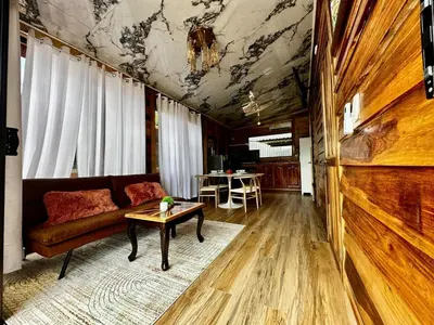 a living room with a couch and a table at Tribu Bungalow 1 Modern and Centrally Located in Fortuna