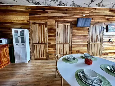 a kitchen with a white table with plates on it at Tribu Bungalow 1 Modern and Centrally Located in Fortuna