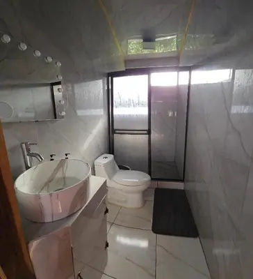 a bathroom with a sink and a toilet at Tribu Bungalow 1 Modern and Centrally Located in Fortuna