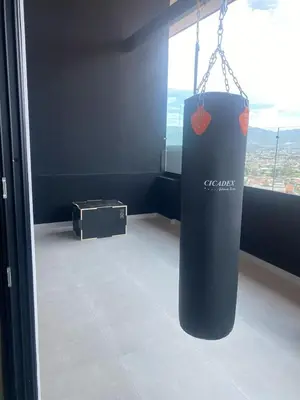 a room with a window with a bag hanging from a chain at Apartamento en Barrio Escalante in San José