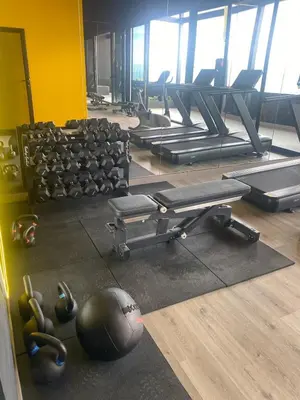 a gym with a ball on the floor next to machines at Apartamento en Barrio Escalante in San José