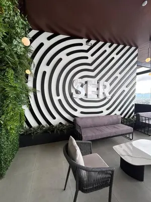 a room with a couch and chairs and a wall at Apartamento en Barrio Escalante in San José