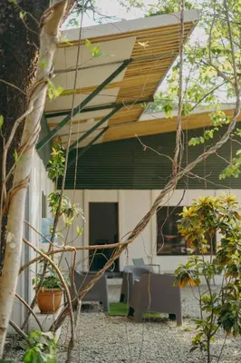 a house with awning on the side of it at Chilamate Rainforest Beach Retreat in Nosara