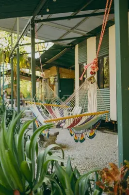 a couple of hammocks hanging from a porch at Chilamate Rainforest Beach Retreat in Nosara