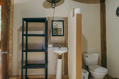 a bathroom with a toilet and a sink at Chilamate Rainforest Beach Retreat in Nosara