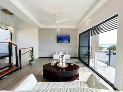 a living room with a couch and a table at Casa Solana in Puntarenas