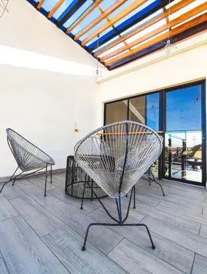 two chairs sitting on a patio with a view of the ocean at Casa Solana in Puntarenas