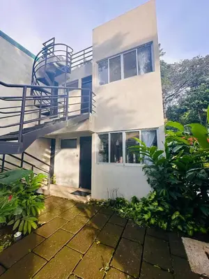 a white house with a staircase and a balcony at Villa Alexandra in Punta Leona
