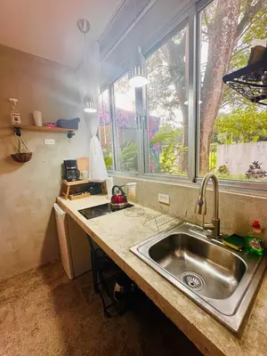 a kitchen with a sink and a window at Villa Alexandra in Punta Leona