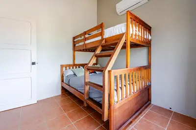 two bunk beds in a room with at Casa Fe- Newly Renovated 2 bedroom condo in Ocotal