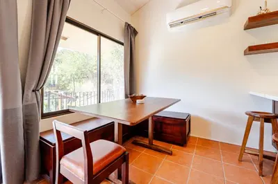 a dining room with a table and a window at Casa Fe- Newly Renovated 2 bedroom condo in Ocotal