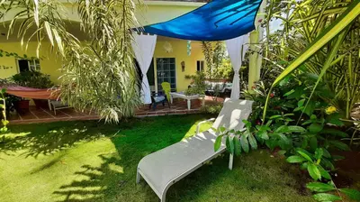 a bench in the yard of a house at Down by the Sea, the beachfront Apartment & Studio in Puerto Coyote