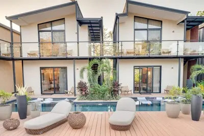 an exterior view of a house with a swimming pool at The Bungalows #10 - Boutique Hotel in Flamingo Beach - Top Level Studio in Playa Flamingo