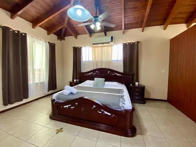 a bedroom with a bed and a ceiling fan at Casa Amura in Liberia