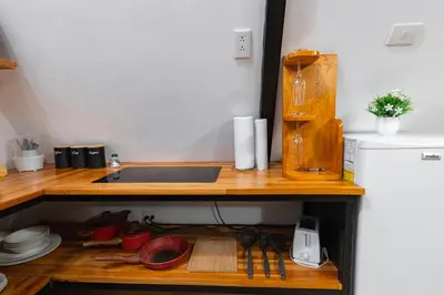 a kitchen counter with a sink and some dishes at A Frame Home in Cebadilla