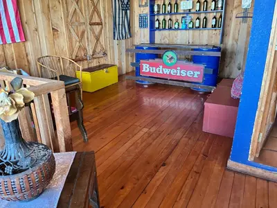 a living room with a wooden floor and a play area at Vista de montaña in Barva