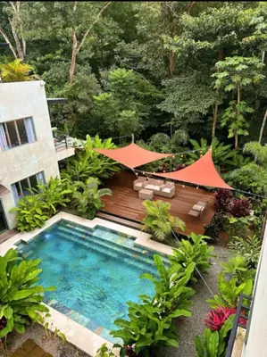 an overhead view of a swimming pool in a garden at Villa Mary in Punta Leona