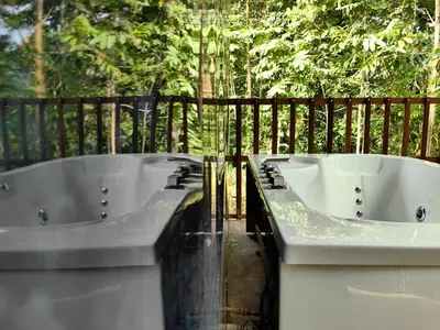 two white bath tubs sitting on top of a balcony at Sloth House in San Isidro