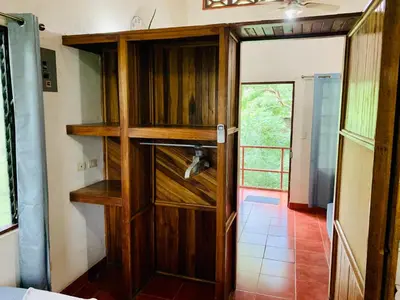 a wooden cabinet in a room with a door at Apartamentos El Labrador in Tamarindo
