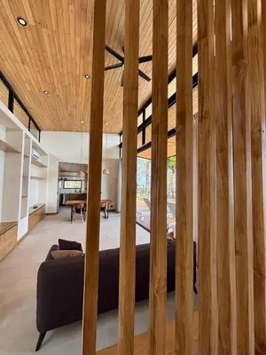 a room with a bed and wooden walls at Mar a Cielo Brand New Ocean View Retreat in Mal País