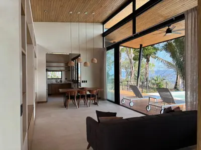 a living room with a couch and a table at Mar a Cielo Brand New Ocean View Retreat in Mal País