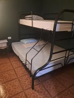 a couple of bunk beds in a room at Sunset House Hostel in Liberia