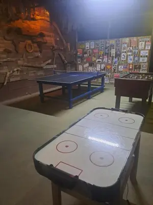 a ping pong table in a room with a ping pong table at Sunset House Hostel in Liberia